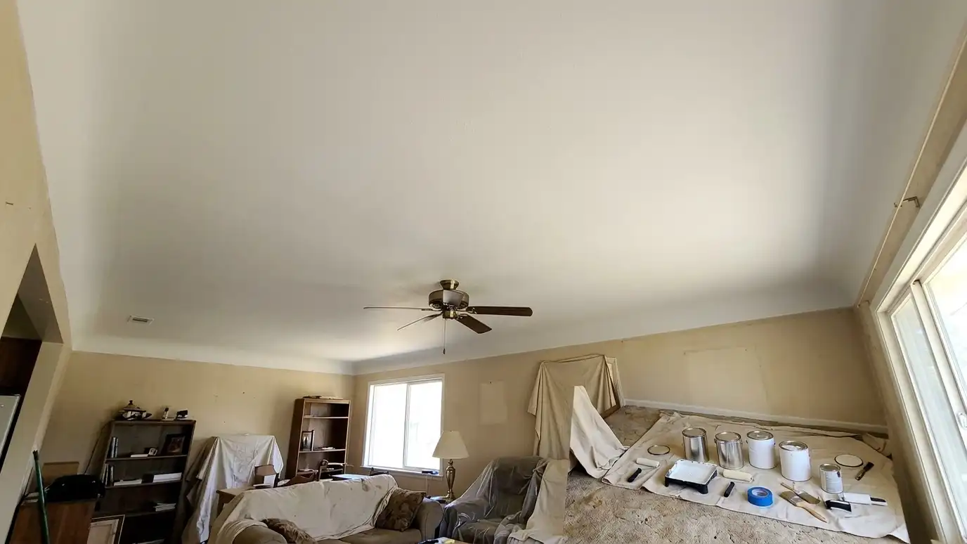 After: a bedroom ceiling with a smooth, bright, freshly painted ceiling