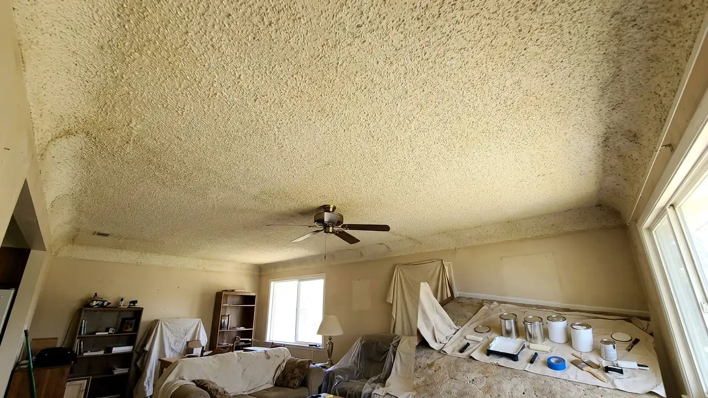 Before: a bedroom ceiling with a dated, bumpy popcorn textured ceiling